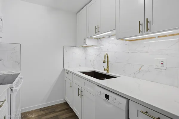 a kitchen with sink and cabinets