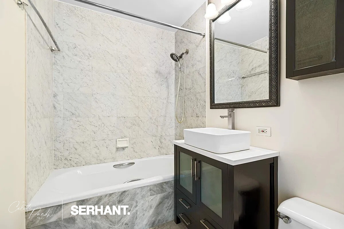 2 South End Avenue, Unit 6J Manhattan, NY 10280 - Photo 10 of 19 a bathroom with a sink toilet tub and shower
