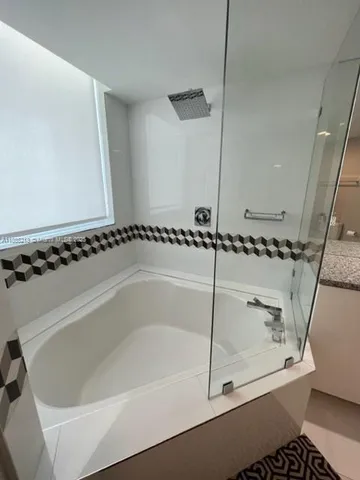 a bathroom with a bathtub and shower