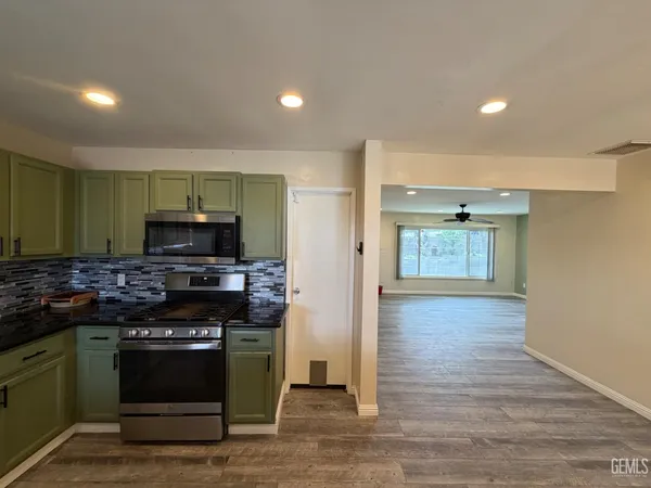a kitchen with stainless steel appliances a stove and a refrigerator