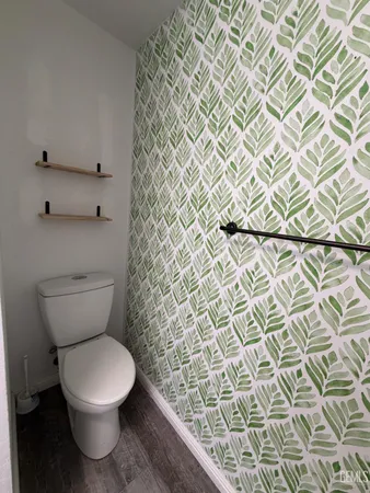 a white toilet sitting next to a shower curtain