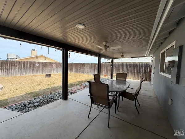 a view of a patio with table and chairs and wooden floor