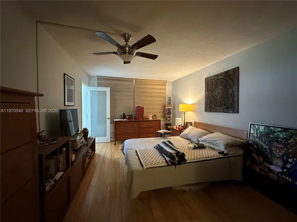a bed room with bed furniture and a flat screen tv