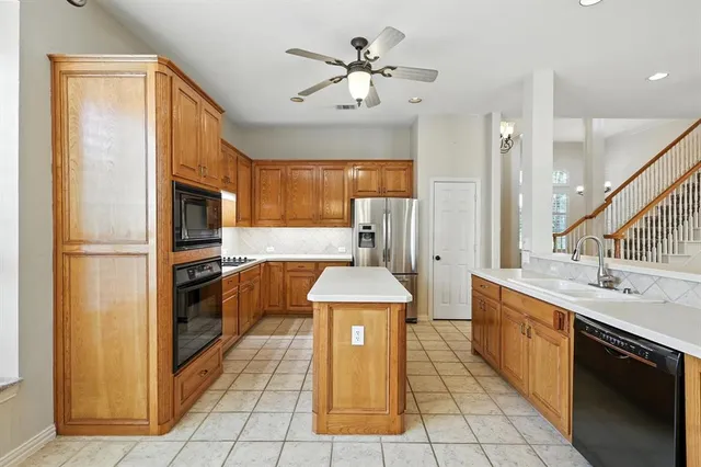 a kitchen with stainless steel appliances granite countertop a stove refrigerator and cabinets