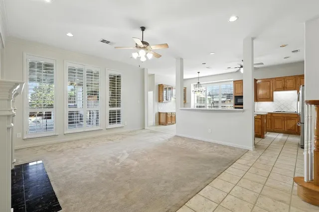 a view of an empty room with a kitchen