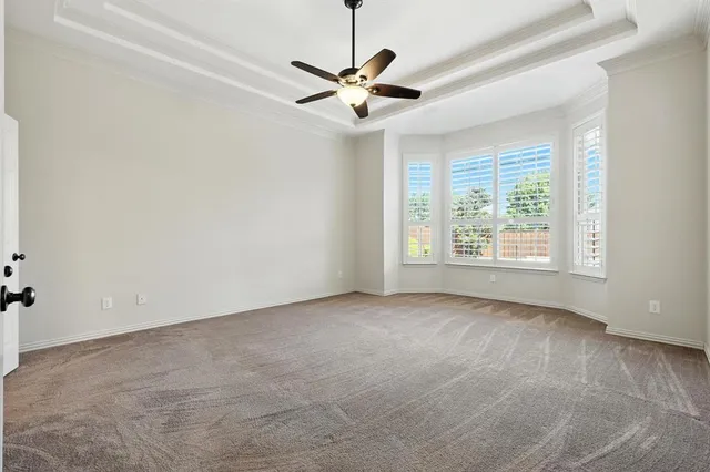 a view of a livingroom with a ceiling fan and window