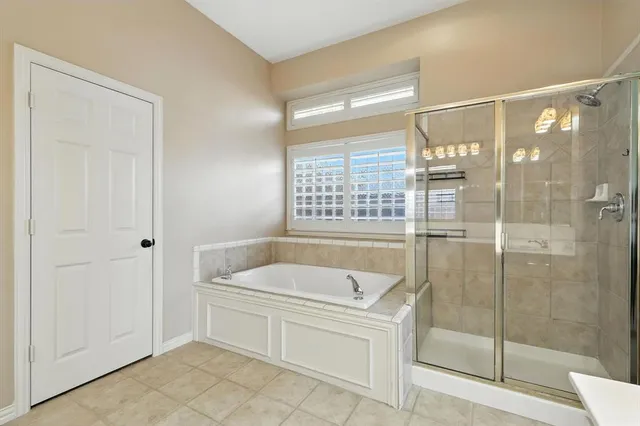 a bathroom with a tub and shower
