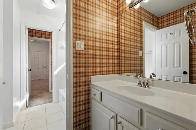 a bathroom with a sink shower and a mirror