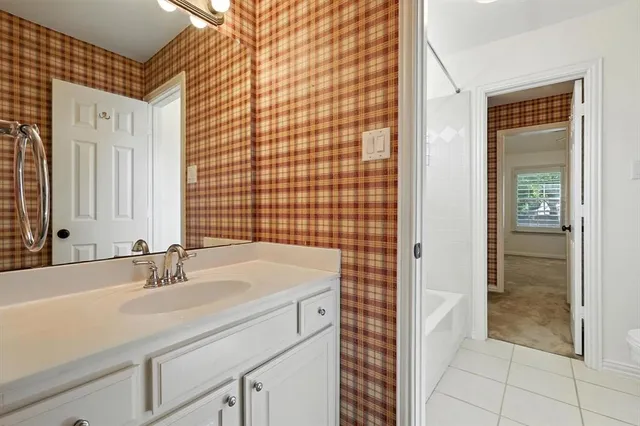 a bathroom with a sink shower and a mirror