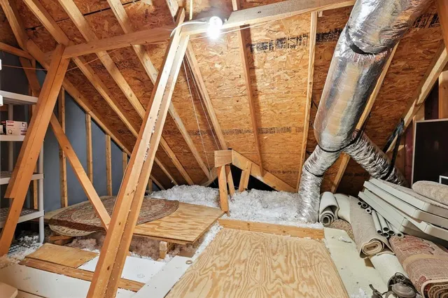 a view of a room with wooden floor and door