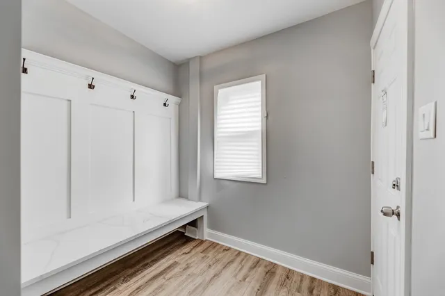 a room with a window and a wooden floor