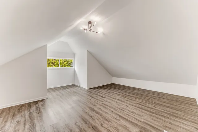a view of an empty room and wooden floor