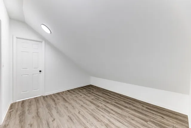 a view of room with wooden floor and fan