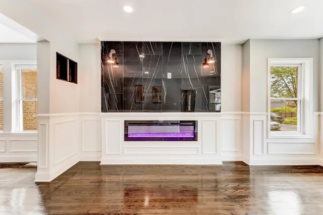 a view of a door with wooden floor and windows