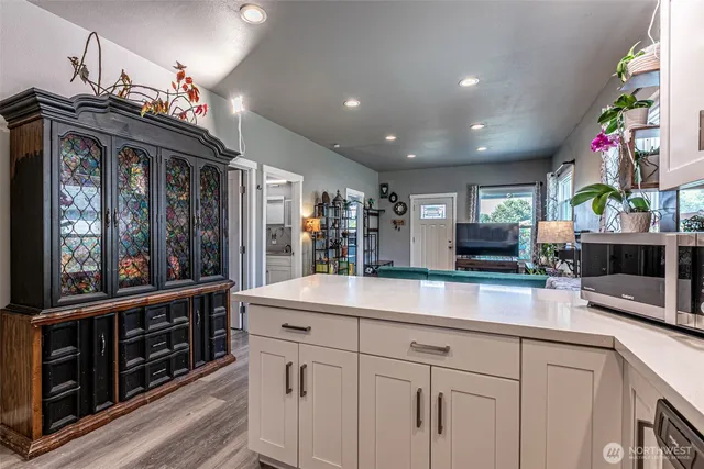 a kitchen with granite countertop a sink and cabinets