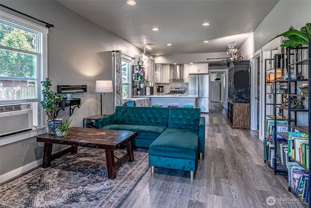 a living room with furniture and a book shelf