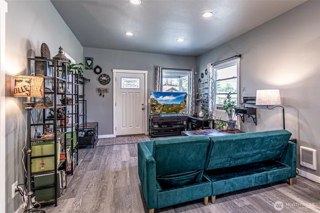 a living room with furniture a window and bookshelf