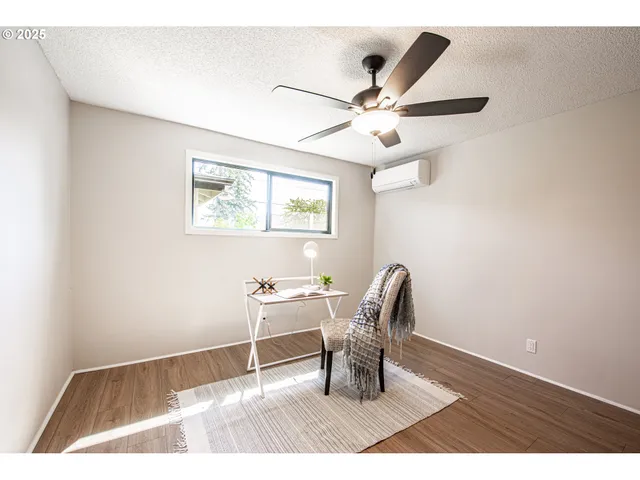 a workspace with wooden floor and a window