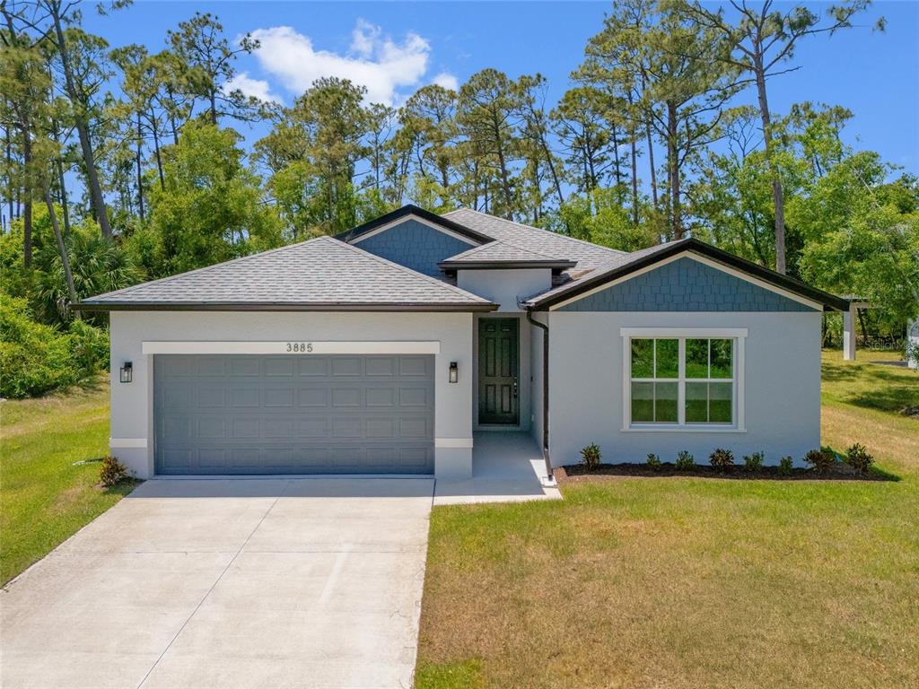 3885 Eagle Pass Street North Port, FL 34286 - Photo 1 of 1 a front view of a house with a garden and yard