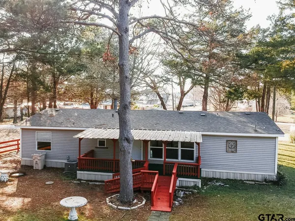 a front view of house with yard covered in snow