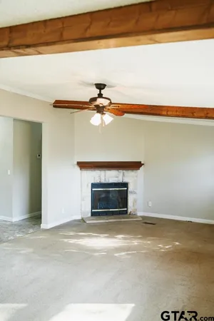 en empty room with windows and fan