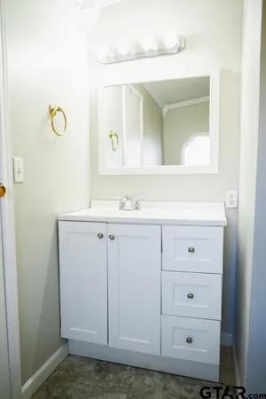 a kitchen with granite countertop a refrigerator and a sink