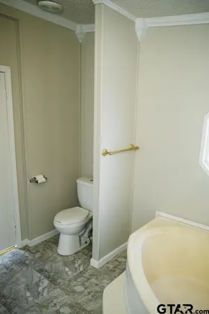 a kitchen with granite countertop a sink and white cabinets