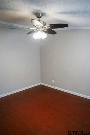 a view of a room with wooden floor and window