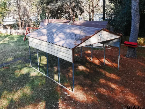 a backyard of a house with table and chairs
