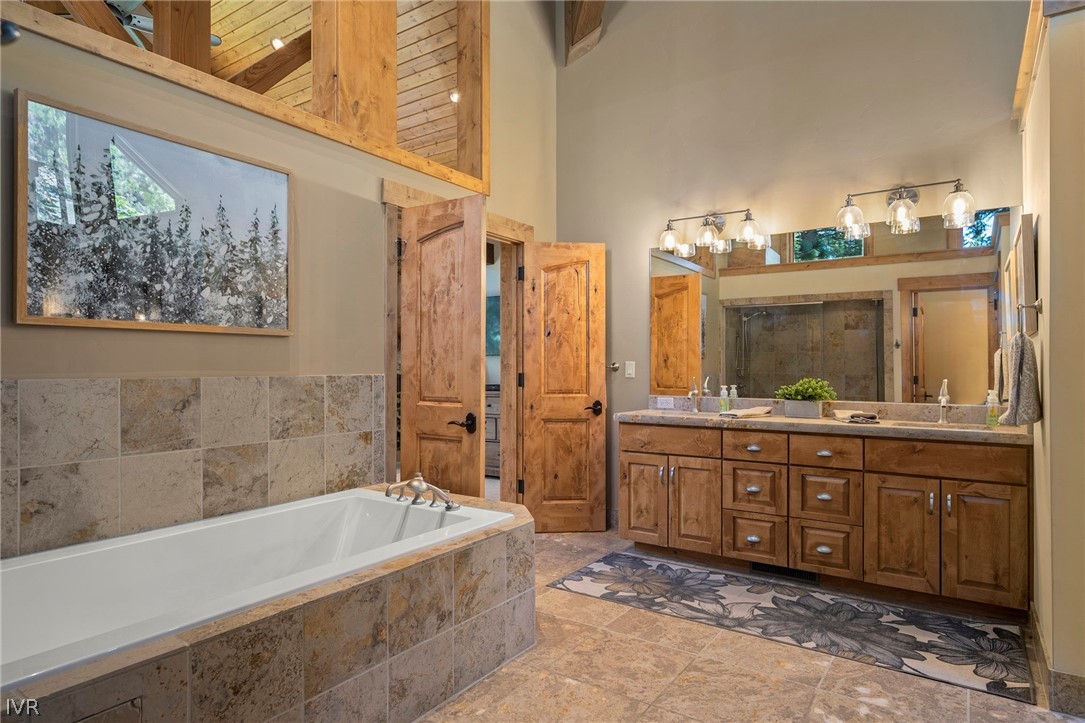 623 Tyner Way Incline Village, NV 89451 - Photo 21 of 35 a bathroom with a granite countertop tub sink and mirror