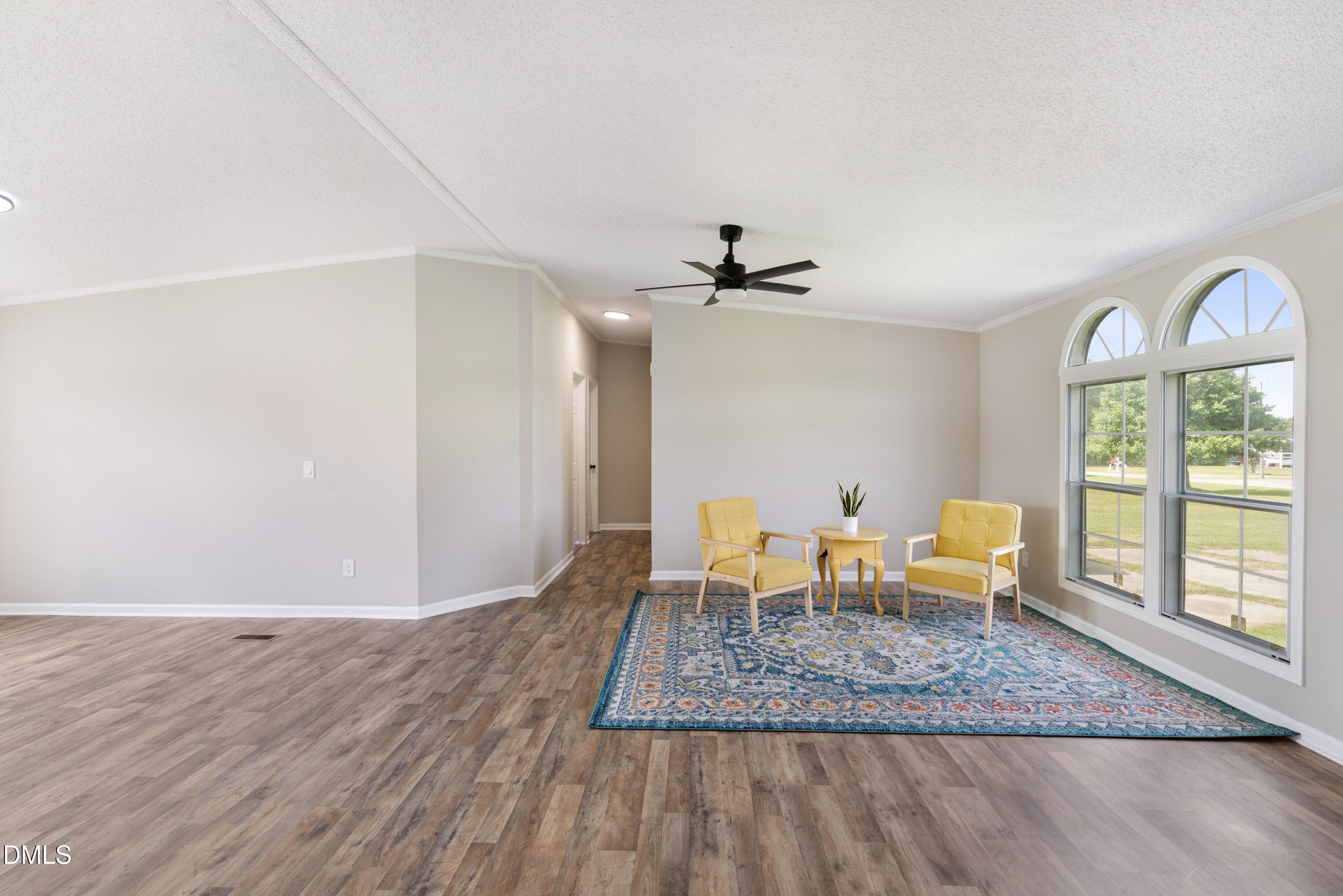 2048 Town Crier Road Kinston, NC 28504 - Photo 12 of 48 a view of dining room and livingroom with furniture wooden floor a rug and a chandelier