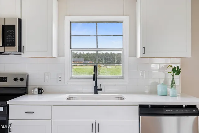 a kitchen with a sink and a window