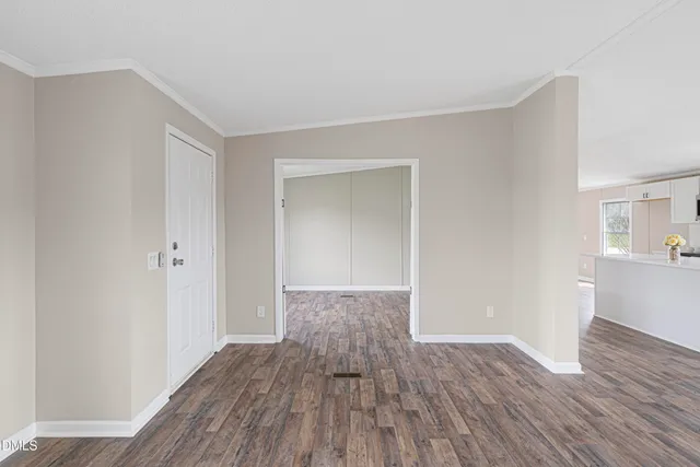 a view of a room with wooden floor and a sink