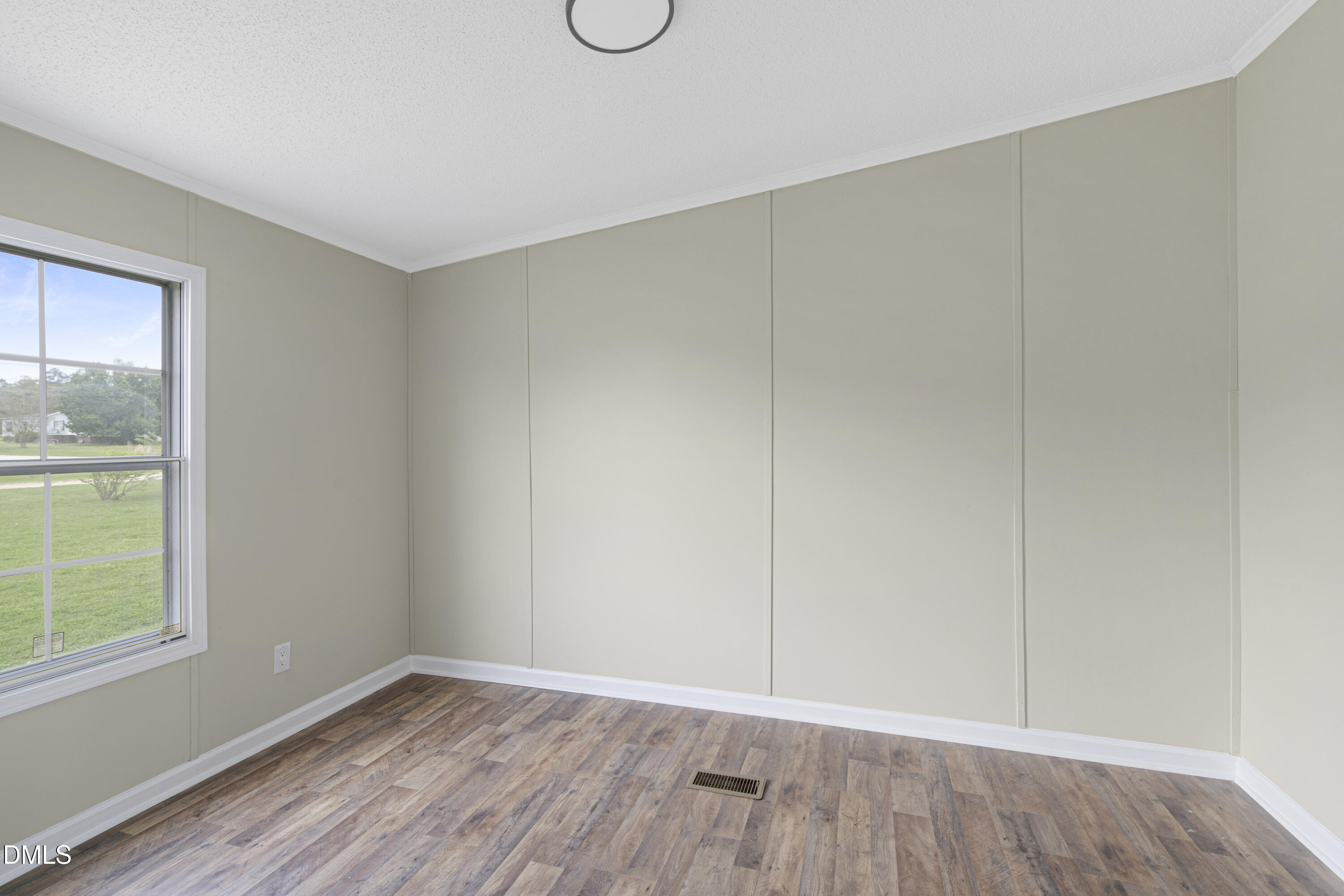 2048 Town Crier Road Kinston, NC 28504 - Photo 23 of 48 a view of an empty room with wooden floor and a window