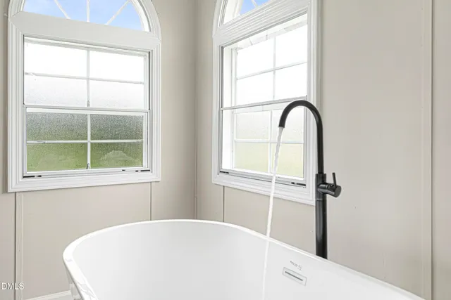 a white bath tub sitting next to a window