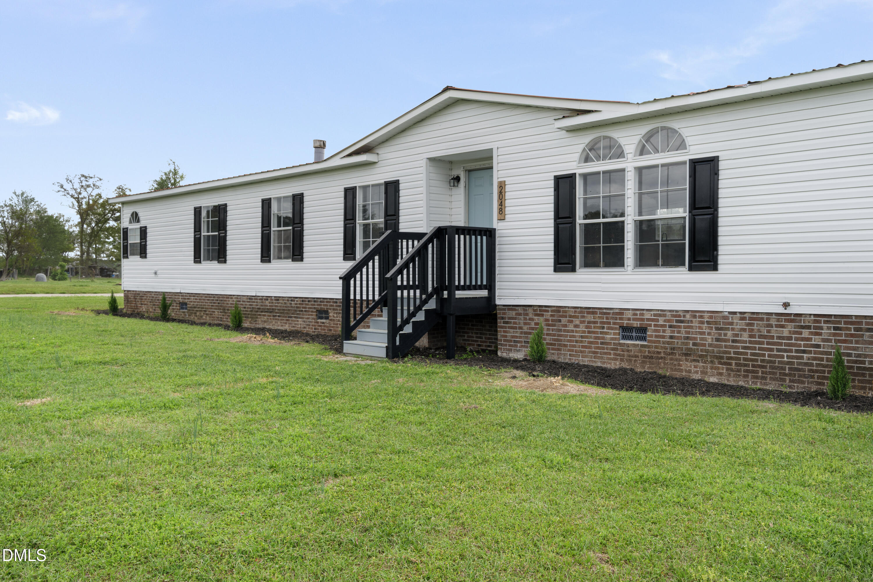 2048 Town Crier Road Kinston, NC 28504 - Photo 3 of 48 a view of a house with a backyard