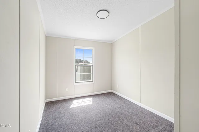 a view of an empty room and closet area
