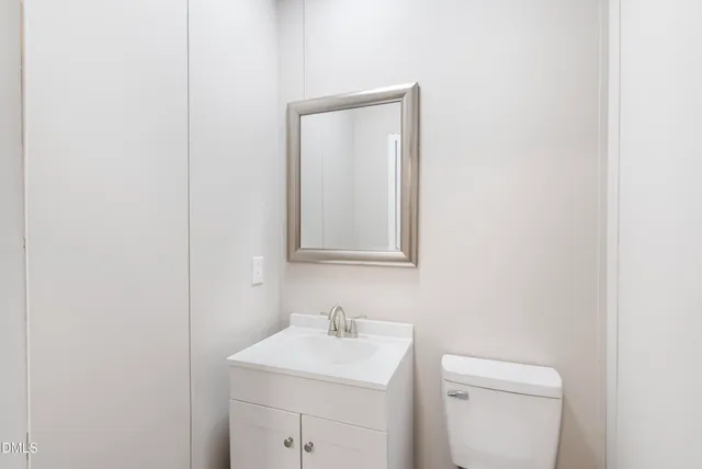 a white toilet sitting next to a bathroom sink