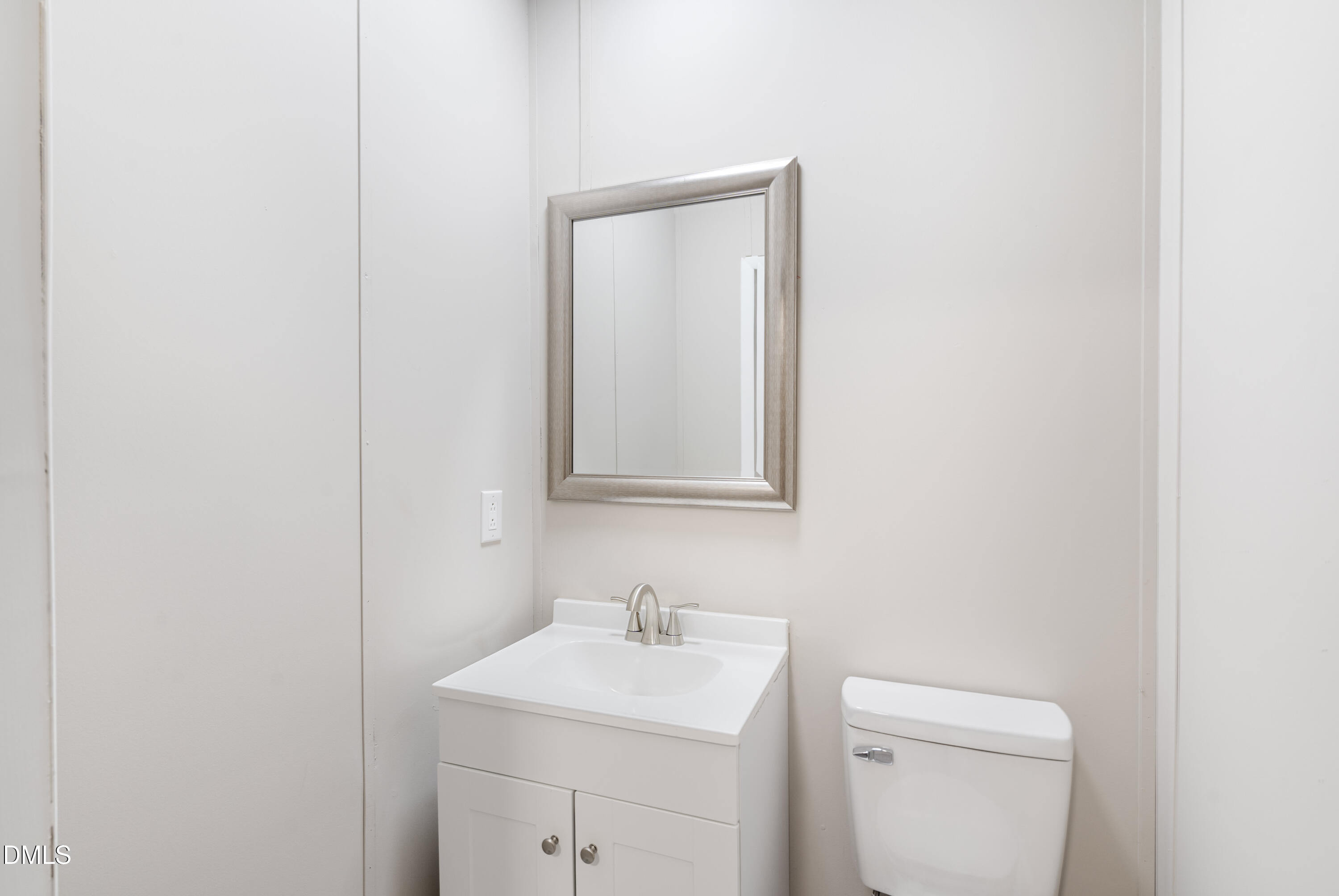 2048 Town Crier Road Kinston, NC 28504 - Photo 38 of 48 a bathroom with a toilet sink vanity and mirror