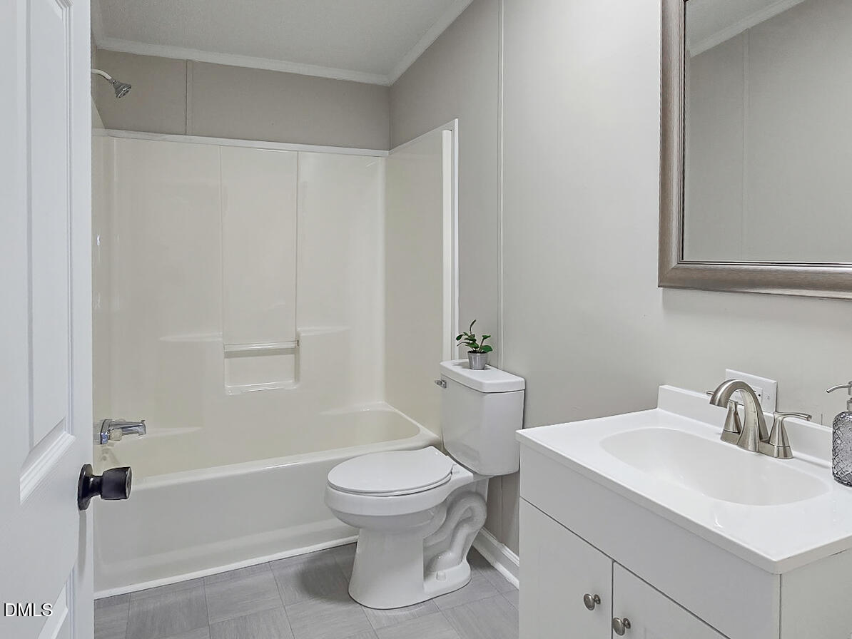 2048 Town Crier Road Kinston, NC 28504 - Photo 40 of 48 a white toilet sitting next to a bathroom sink