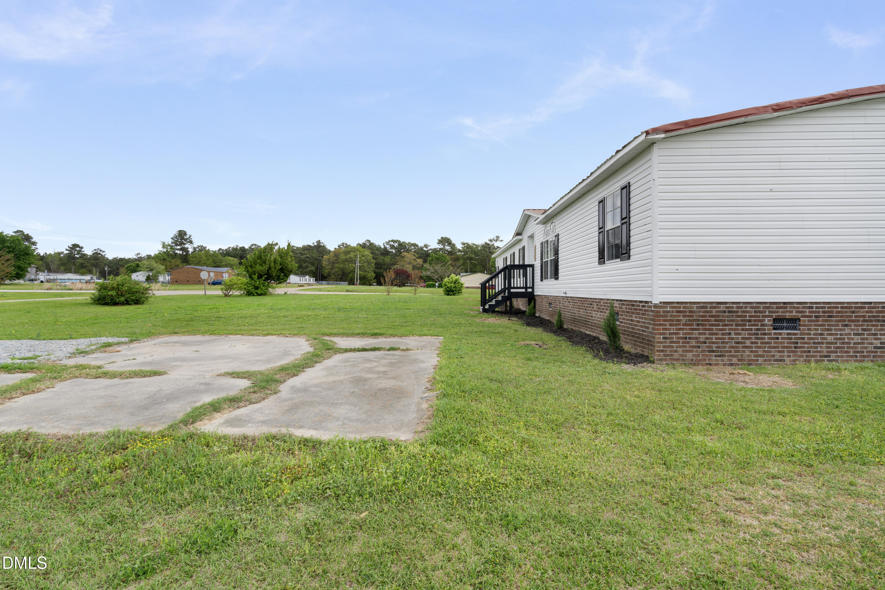 2048 Town Crier Road Kinston, NC 28504 - Photo 46 of 48 a backyard of a house with lots of green space