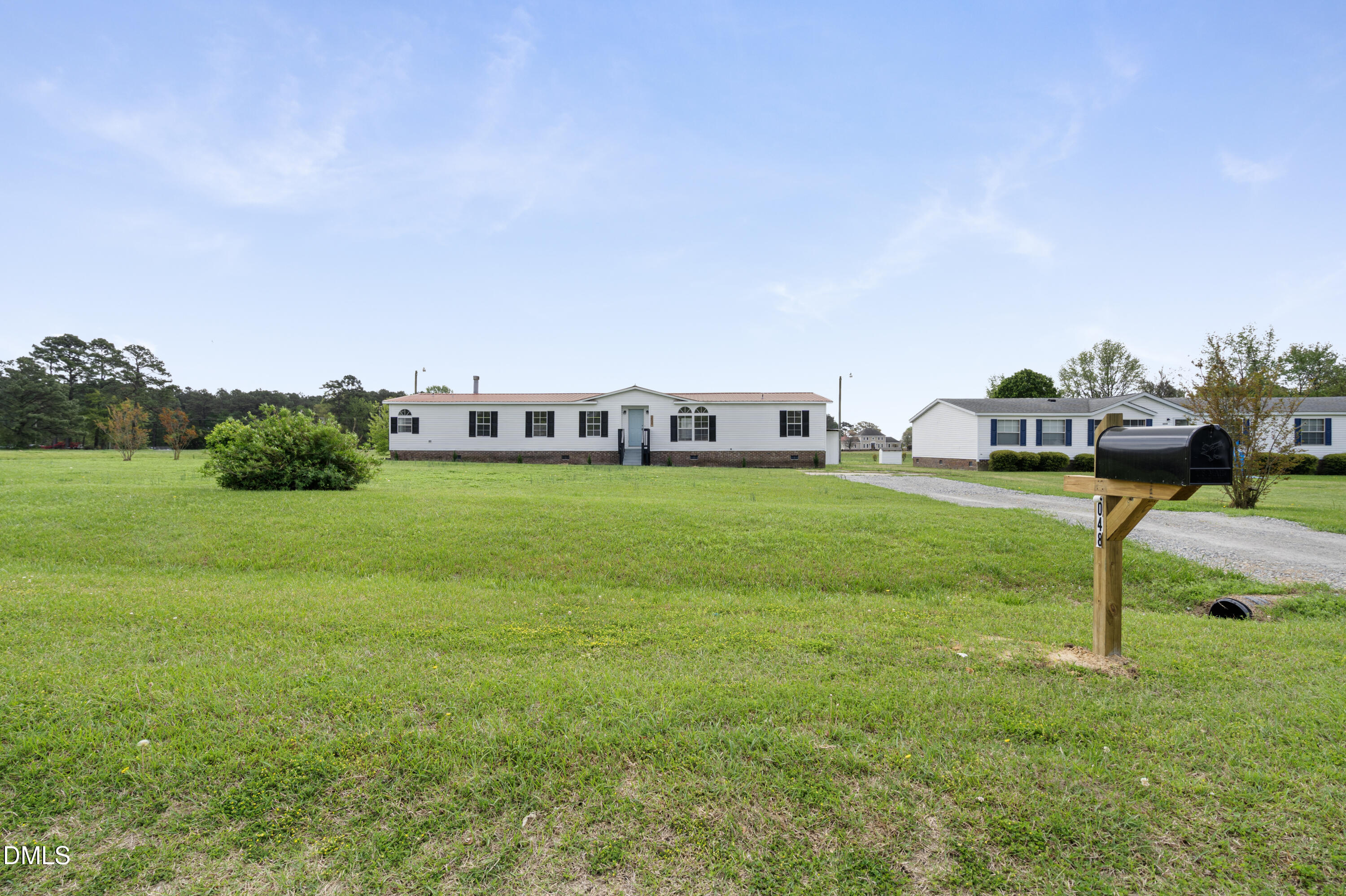 2048 Town Crier Road Kinston, NC 28504 - Photo 6 of 48 a view of a house with a yard and sitting area