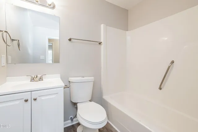 a white toilet sitting next to a bathroom sink