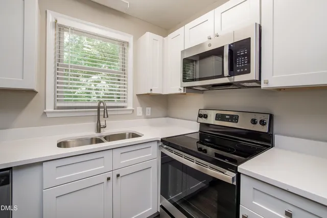 a kitchen with a sink stove and microwave