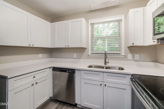 a kitchen with a sink cabinets and window