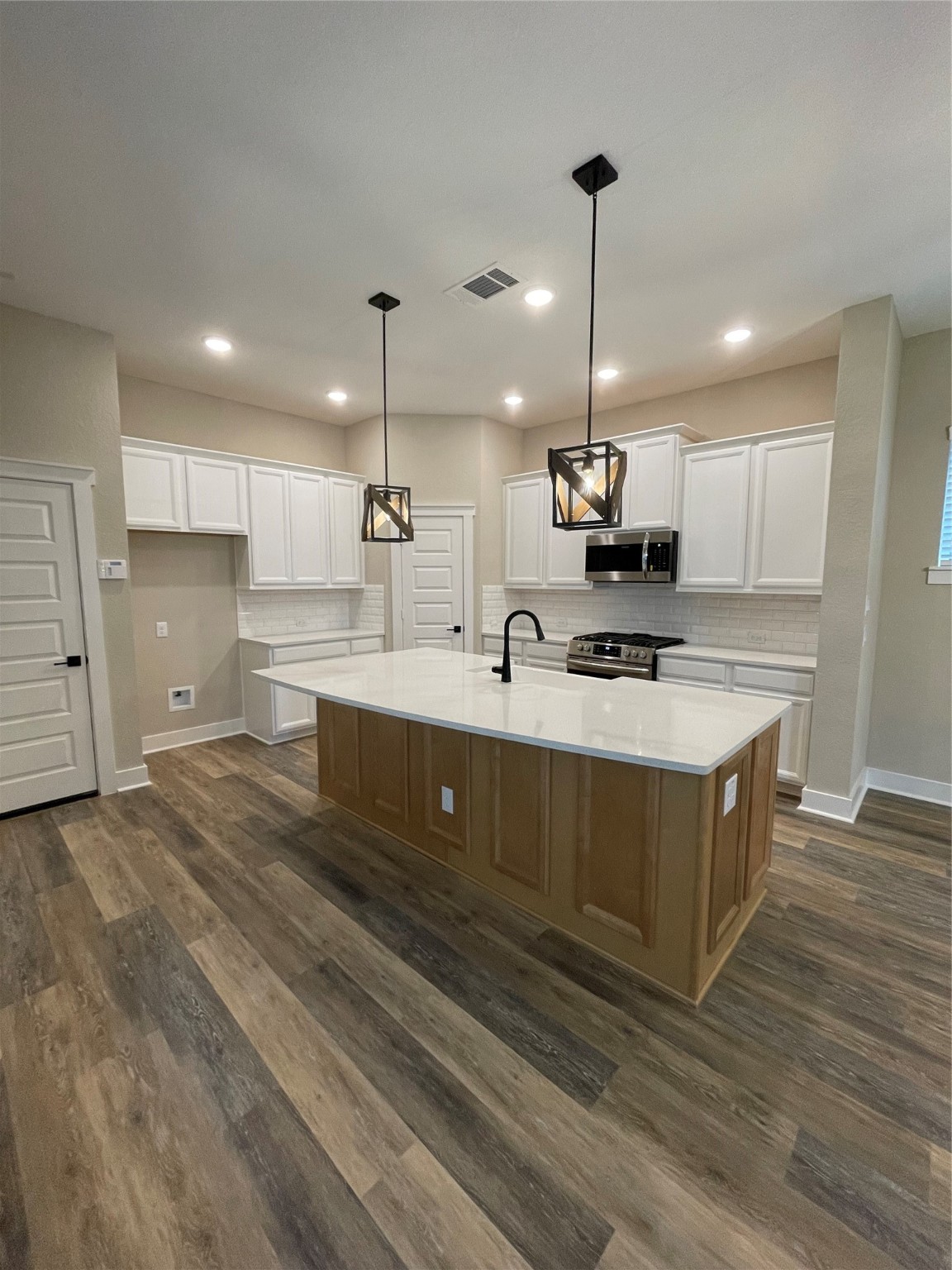 18607 Courteous Way Cypress, TX 77433 - Photo 11 of 37 a kitchen with kitchen island sink stove and refrigerator