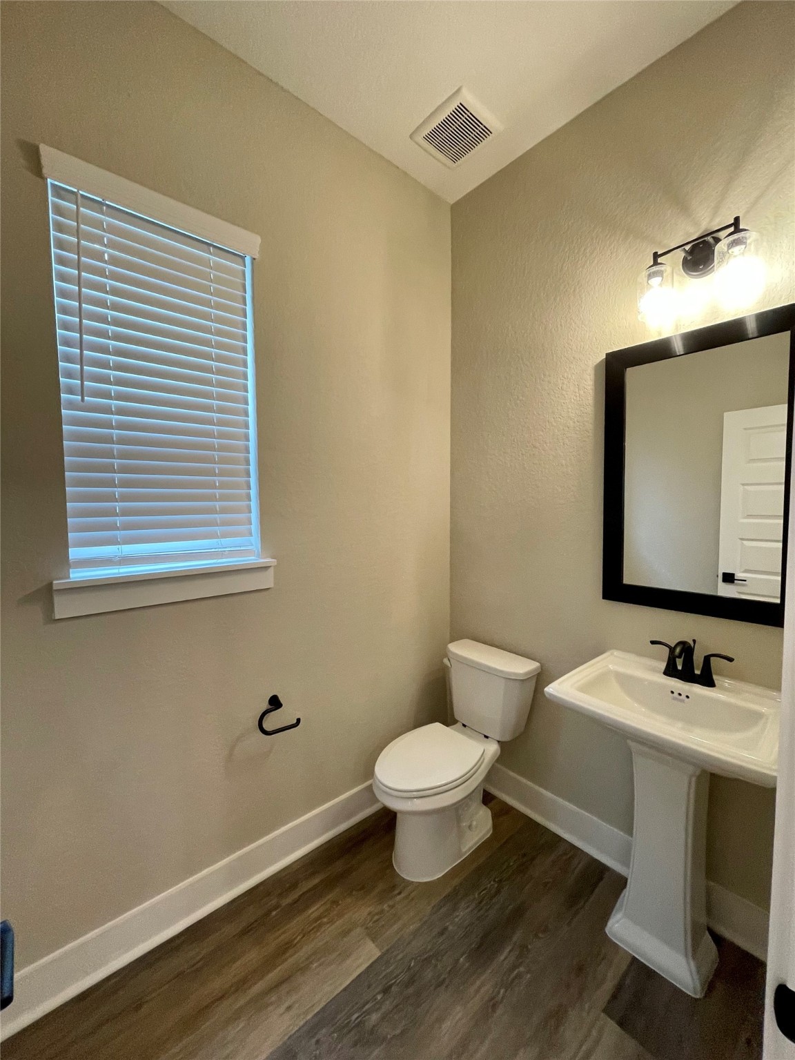 18607 Courteous Way Cypress, TX 77433 - Photo 17 of 37 a bathroom with a toilet a sink and mirror