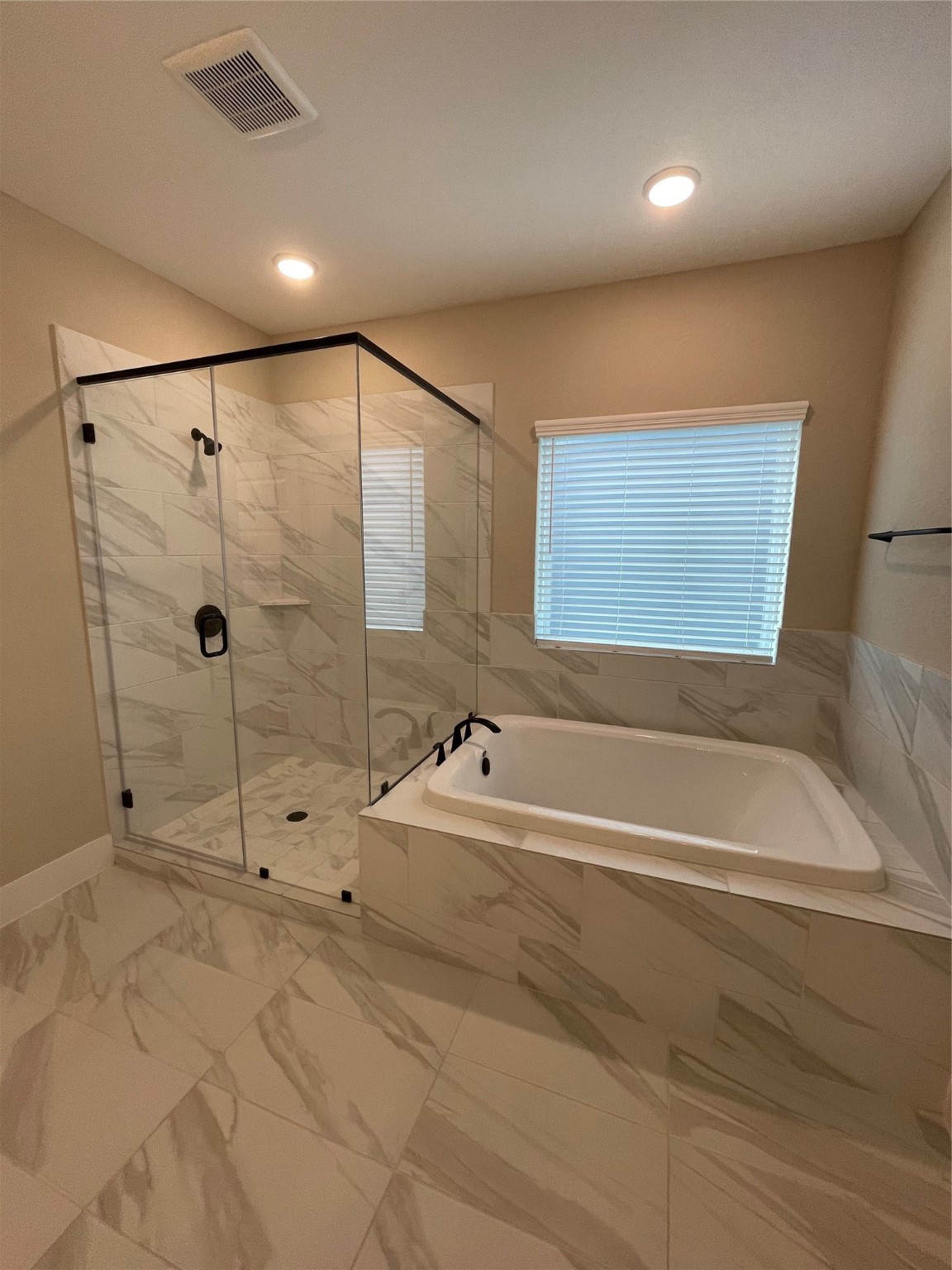 18607 Courteous Way Cypress, TX 77433 - Photo 23 of 37 a bathroom with a bathtub and a shower