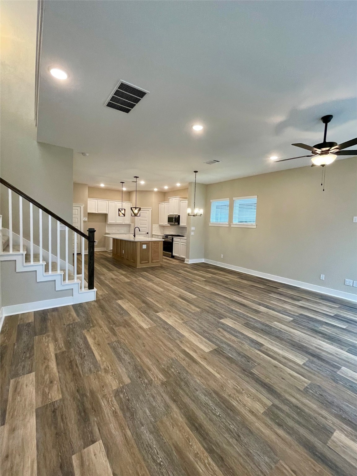 18607 Courteous Way Cypress, TX 77433 - Photo 5 of 37 an empty room with wooden floor fan and windows