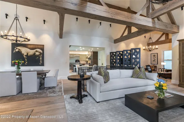 a living room with furniture and a chandelier